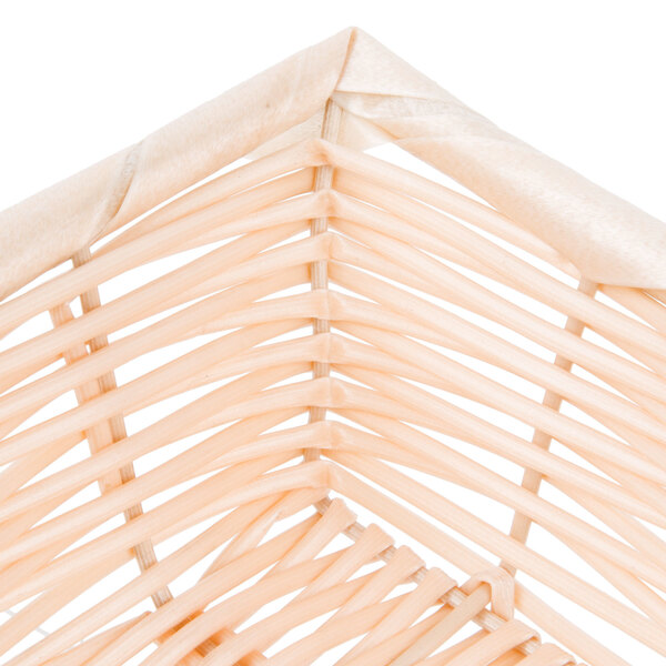 A close up of a Tablecraft rectangular woven rattan-like basket.