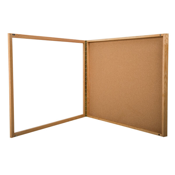 An Aarco wooden frame with a glass panel enclosing a cork board.