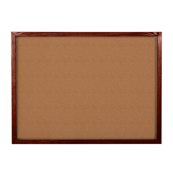 An Aarco cherry wood framed cork board.