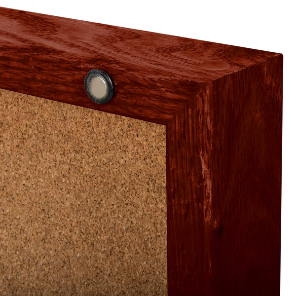An Aarco enclosed cork board with a cherry finish.