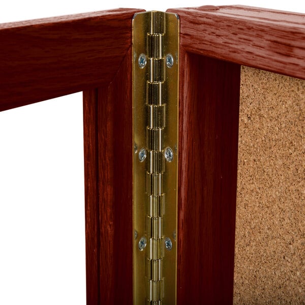 An Aarco wooden display case with gold hinges.