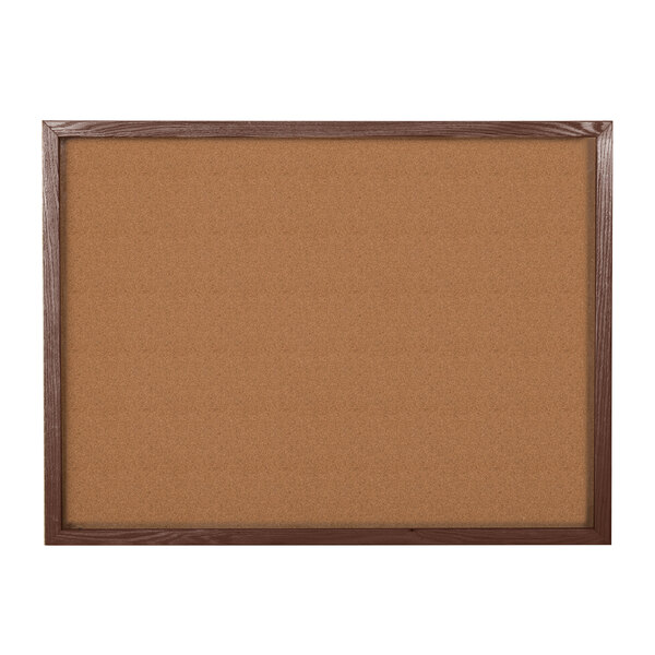An Aarco walnut enclosed cork board.