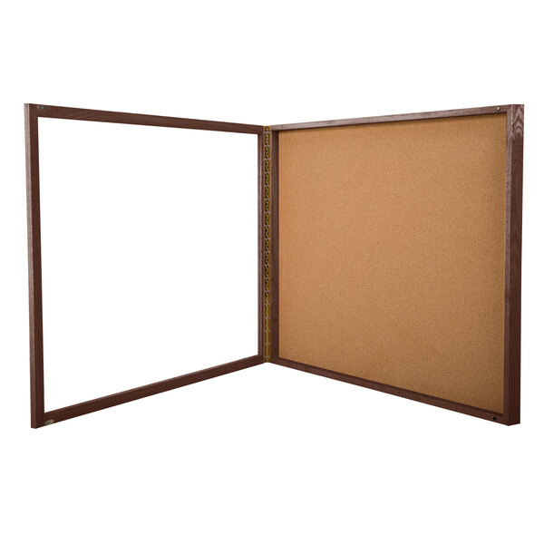 A brown and white enclosed display case with cork and white boards inside.