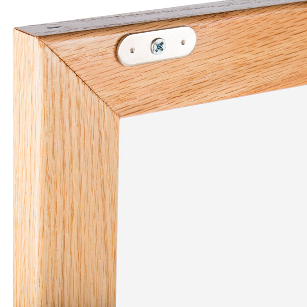 A natural oak wood frame with a hinged door.