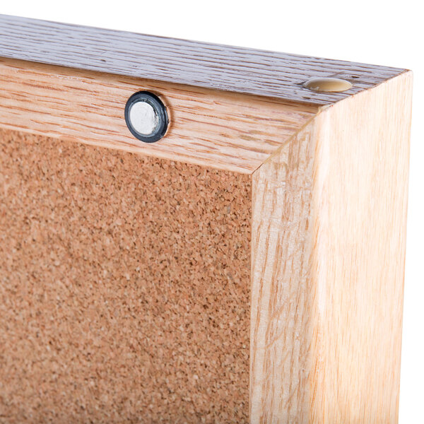 An Aarco enclosed display case with a cork board inside.