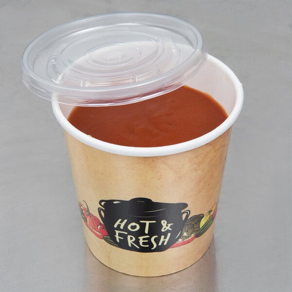 A Choice paper soup cup with a vented plastic lid containing soup on a deli counter.