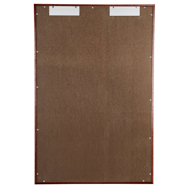 A brown board with a wooden frame and two doors with white paper inside.