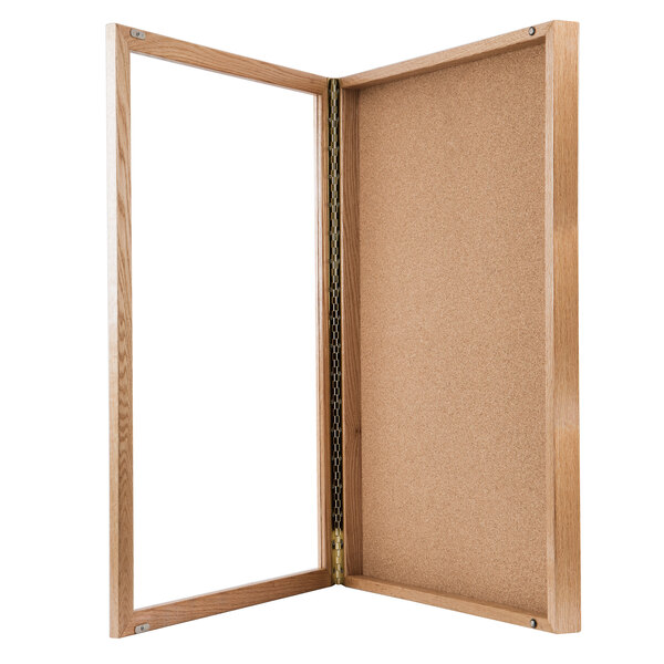 A wooden Aarco enclosed display case with a glass door.