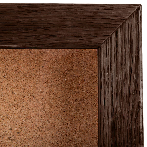 An Aarco walnut enclosed cork board.
