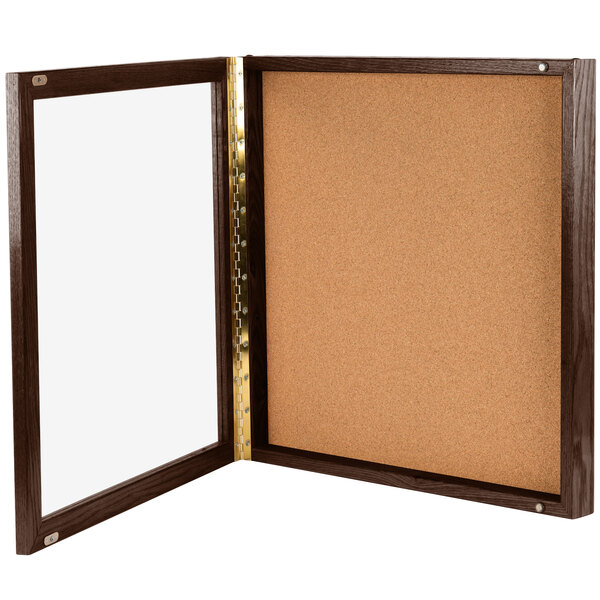 An Aarco walnut framed cork board.