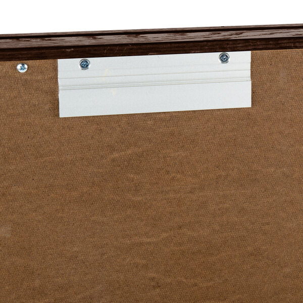 A white board with a walnut finish and a black background inside.