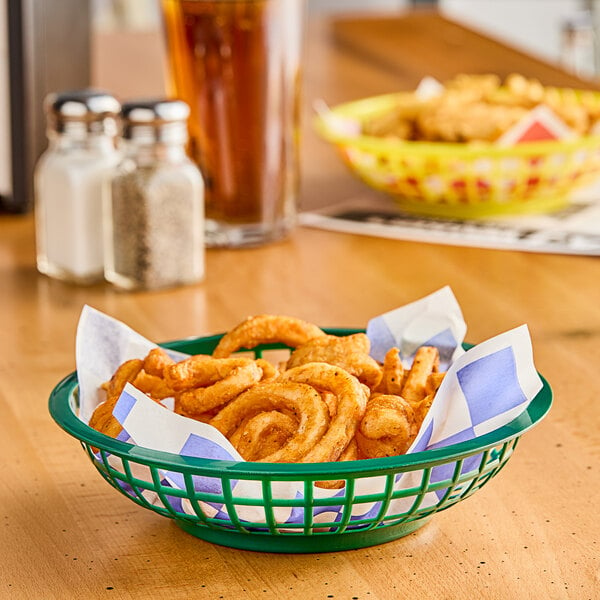 A Choice round forest green plastic fast food basket filled with fried food on a table.