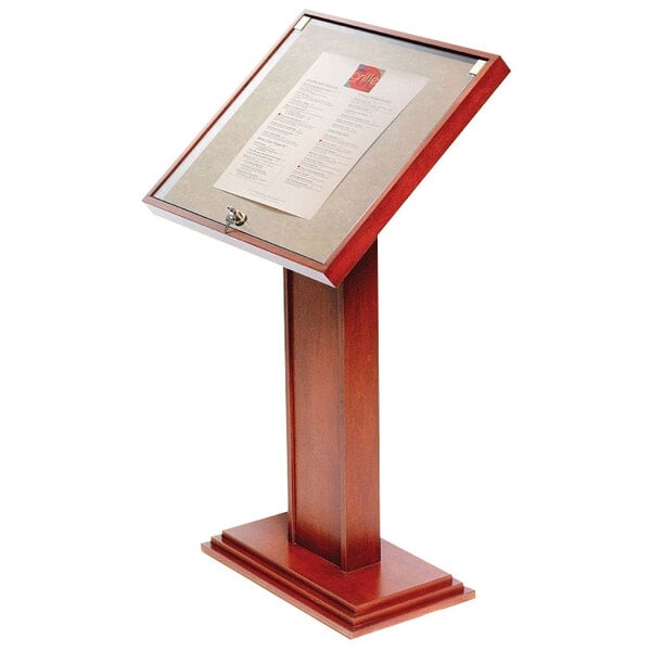 A Bon Chef oak menu display stand on a table with a menu board.