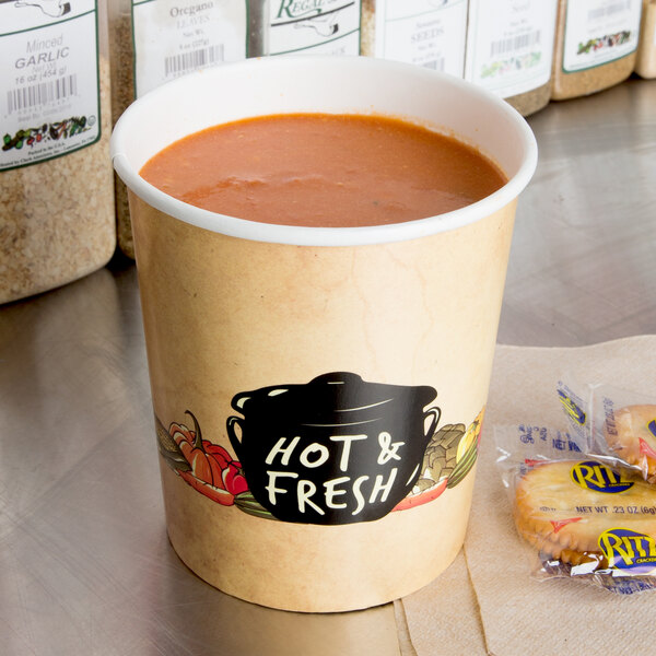 A Choice double poly-coated paper soup cup filled with soup and crackers on a table with a black and white label.