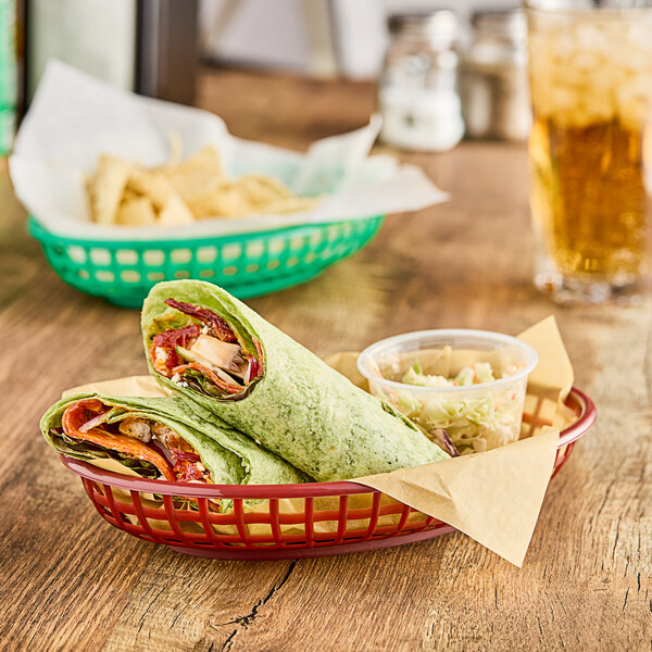 A brown oval plastic fast food basket filled with chips on a table.