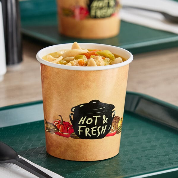 A Choice double poly-coated paper soup cup filled with soup on a tray.