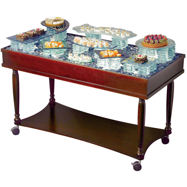 A Bon Chef Underlite Trolley with food on it in a bakery display.