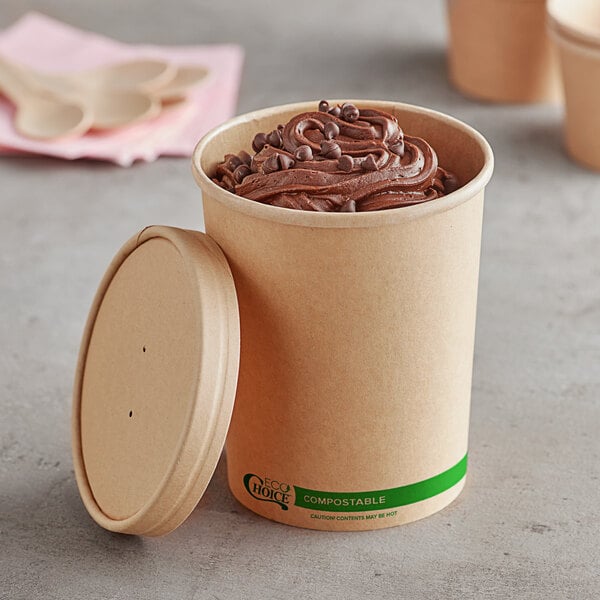 A EcoChoice kraft paper food cup filled with chocolate ice cream and a spoon with a vented lid.