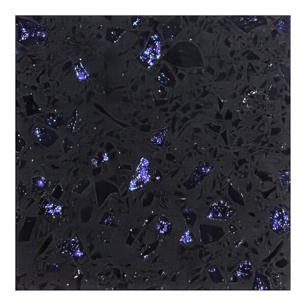 A close-up of an Art Marble Furniture blue galaxy quartz table top with black and blue speckles.