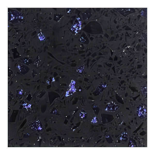 A close-up of an Art Marble Furniture blue galaxy quartz tabletop with black and blue speckles.