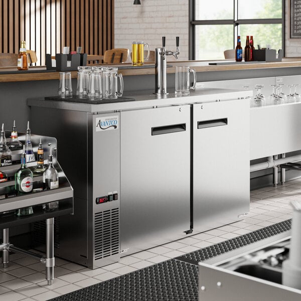 An Avantco stainless steel kegerator with a 2 tap tower on a counter.