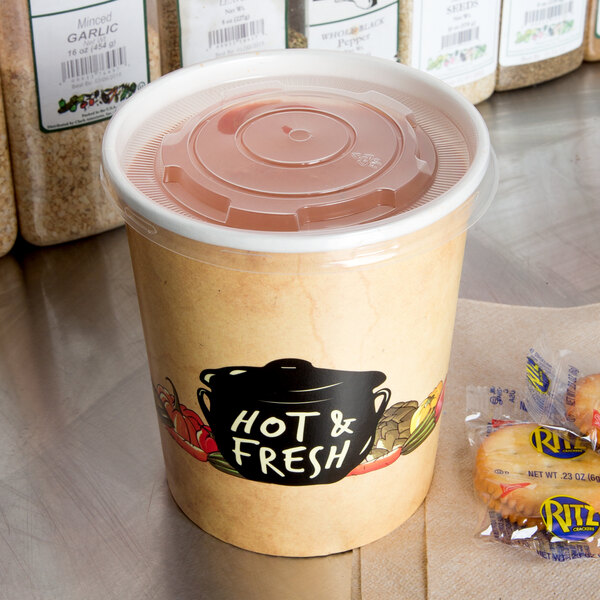 A Choice paper soup container with a vented plastic lid filled with food and a bag of cookies.