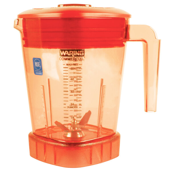 The Raptor orange blender jar with a red lid.