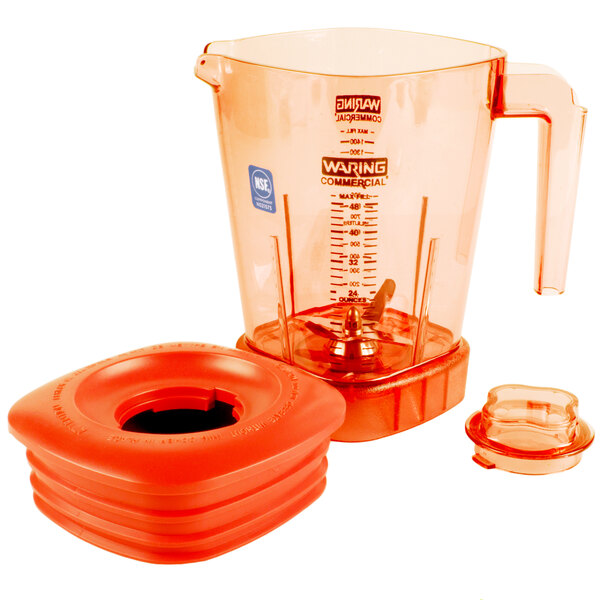 The Waring Raptor orange blender jar with lid on a blender.