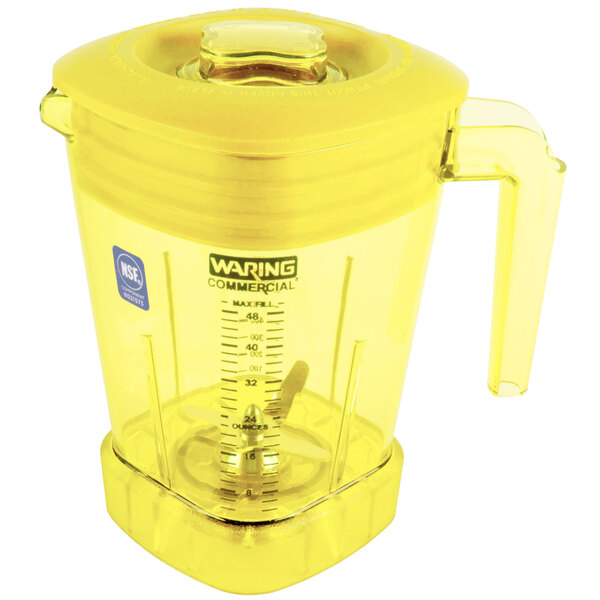 A yellow Waring blender jar with a handle.