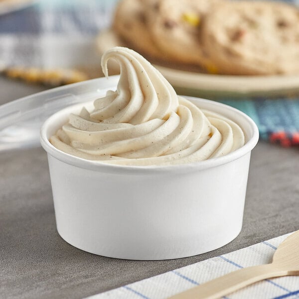 A white Choice paper food cup with ice cream in it and a plastic lid.