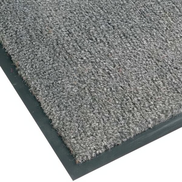A close-up of a gunmetal grey carpet floor mat with black edges.
