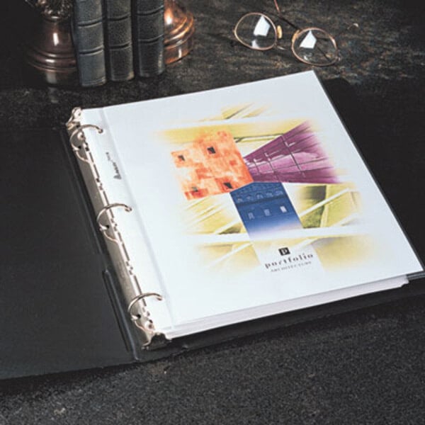 A stack of Avery Diamond Clear sheet protectors on a black binder.