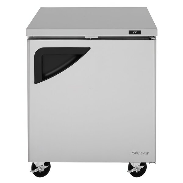 A white Turbo Air undercounter refrigerator with a black handle and wheels.