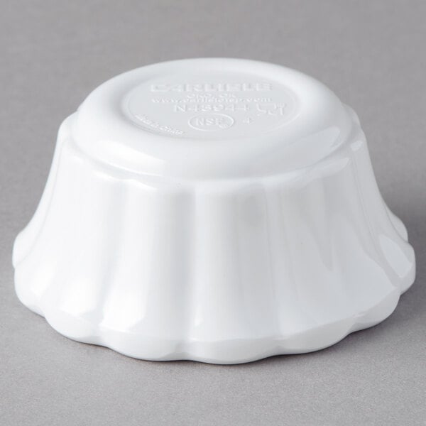 A white Carlisle melamine ramekin with scalloped edges.