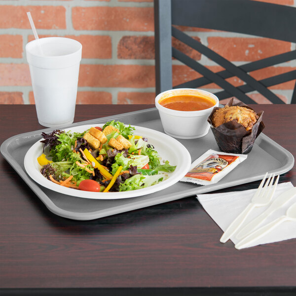 A Vollrath fast food tray with a salad, muffin, and cup of soup on it.