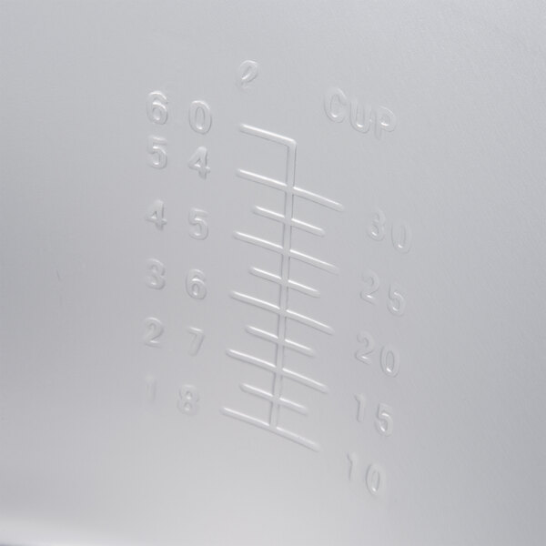 The white measuring cup for a Town rice cooker.
