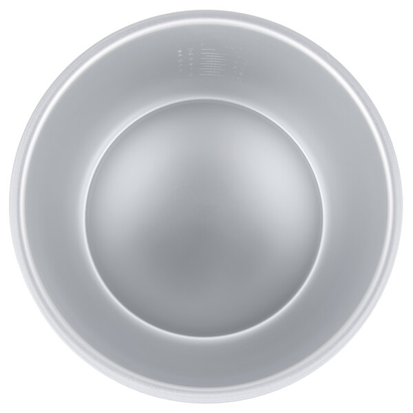 A close-up of a silver bowl with a white surface and lines.