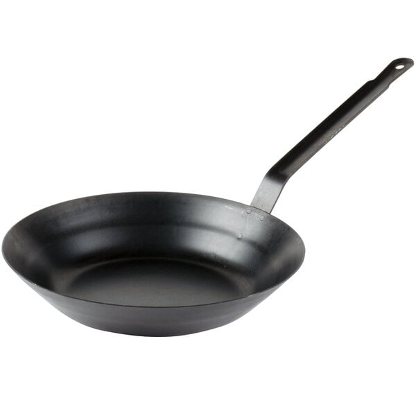 A black Town carbon steel fry pan with a handle.