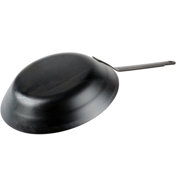 A black Town carbon steel fry pan with a handle.