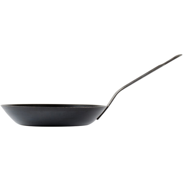 A black pan with a long handle.