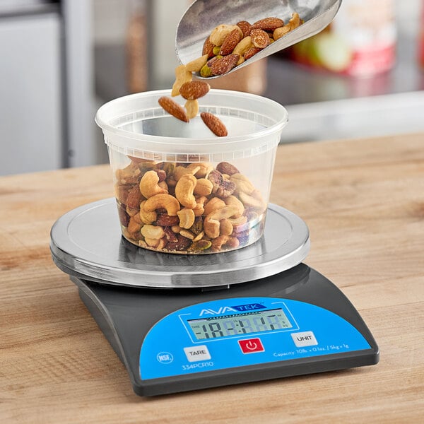 A person using an AvaWeigh round portion scale to pour nuts into a container.
