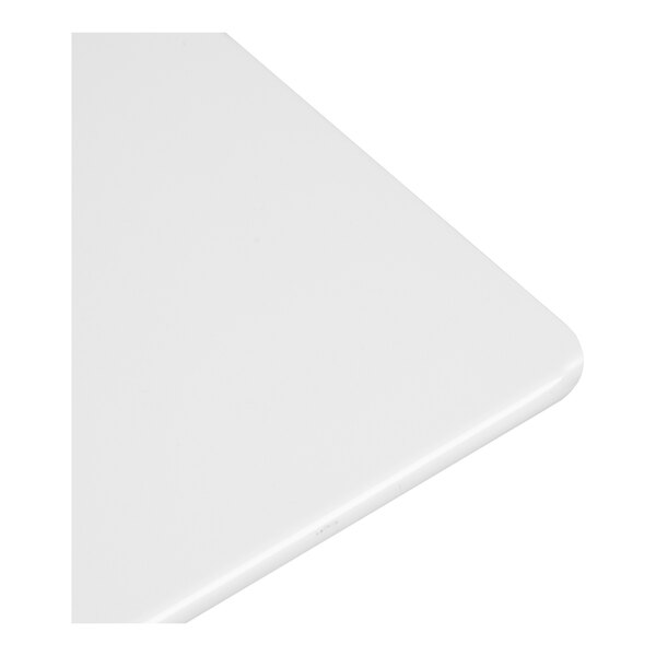 A close-up view of a smooth, white, rectangular surface with rounded edges.