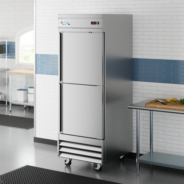 A stainless steel, single-section reach-in refrigerator with two solid half doors on casters.