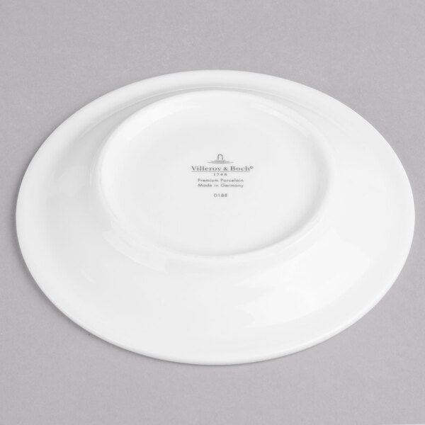 A white Villeroy & Boch porcelain saucer with black text reading "Villeroy & Boch" on it.