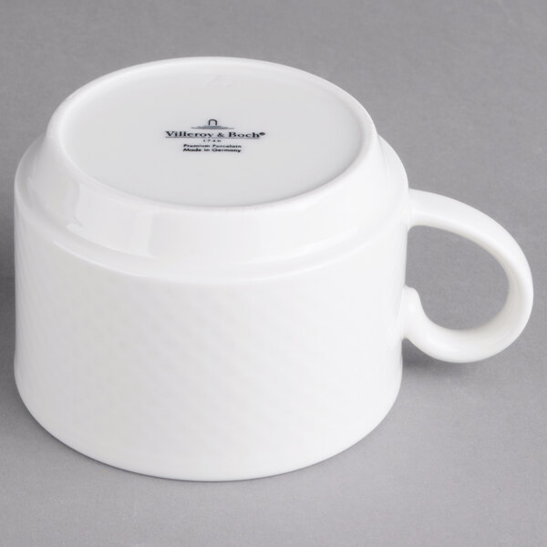 A Villeroy & Boch white porcelain stackable coffee cup with a handle.