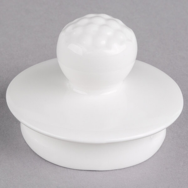 A white porcelain lid for a Villeroy & Boch coffeepot with a round knob on top.