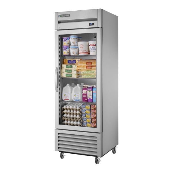 A True stainless steel glass door reach-in refrigerator full of food.