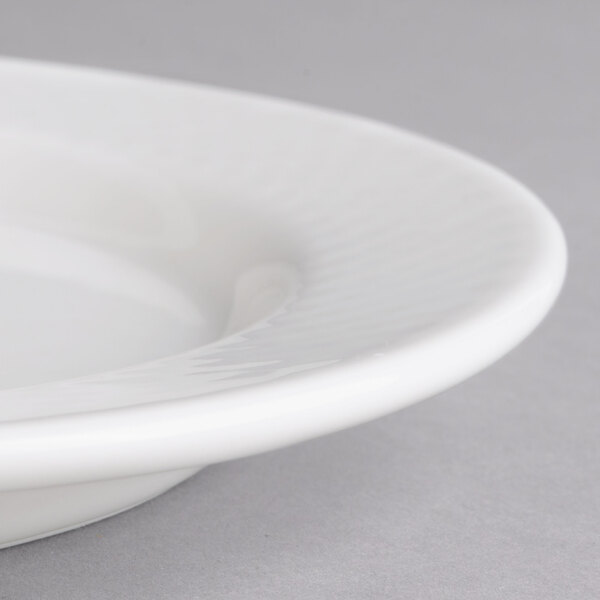 A close-up of a Villeroy & Boch white porcelain small oval pickle dish with a rim.