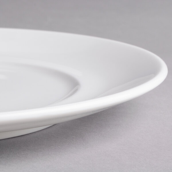 A close-up of a white Villeroy & Boch porcelain flat plate with a small rim.