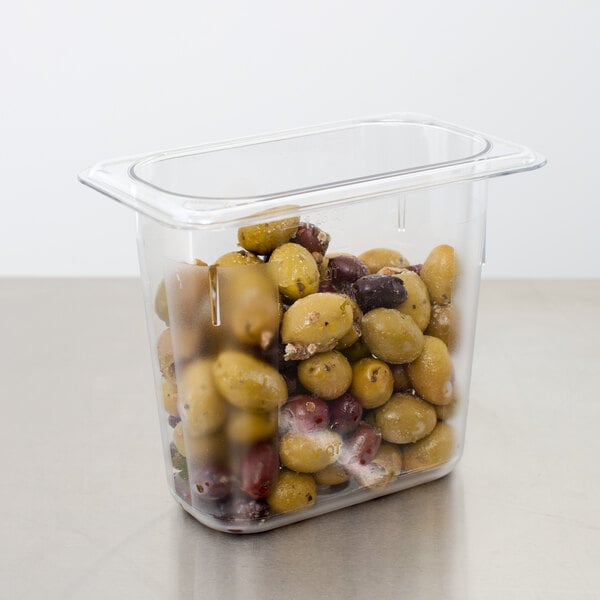 A Cambro clear plastic food pan filled with green and yellow olives.